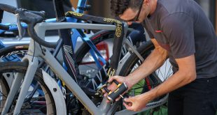 OnGuard lock being used by man securing bikes together with link lock and key based padlock