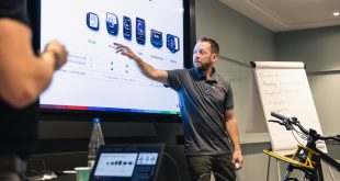 Bosch eBike training session with instructor pointing to large screen with product detail being shown