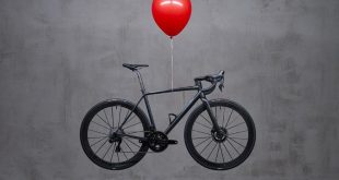 Officine Mattio ultra light bike hovering in mid air, with red ballon tided around the middle of the top tube