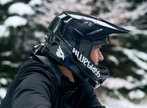 Bluegrass full face MTB helmet on rider paused in snowy wooded setting